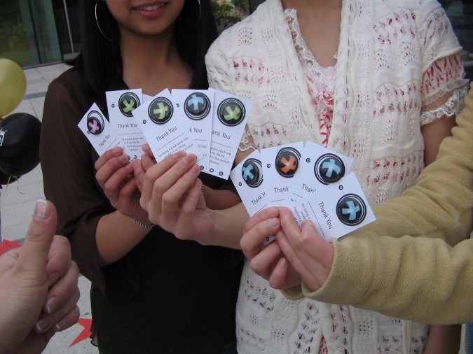 Youth holding up the posi-pins used as part of the campaign.